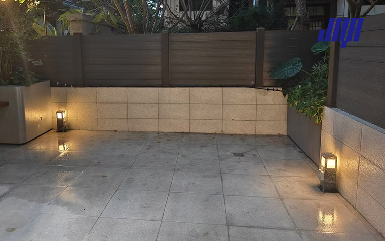 Outdoor Post Light with Outlet - Enhancing Landscape Lighting with Electrical Solutions 52 Real‑life backyard landscape scene of mounted outdoor post light with outlet, providing ambient garden lighting and power supply for outdoor devices and tools