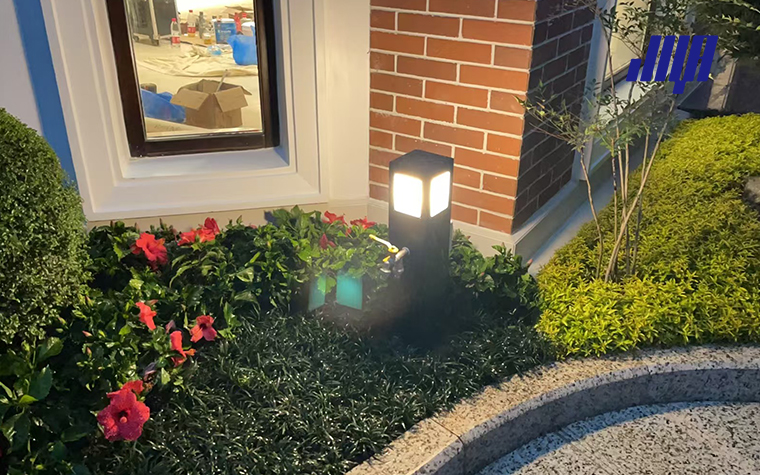 Article cover graphic for outdoor lighting lamp post outlet installation, illustrating adding power outlet function to residential landscape lamp post systems