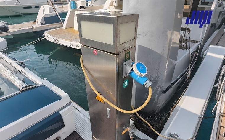 Marina power pedestal installation on floating dock, following NEC 555 electrical safety requirements for yacht docks
